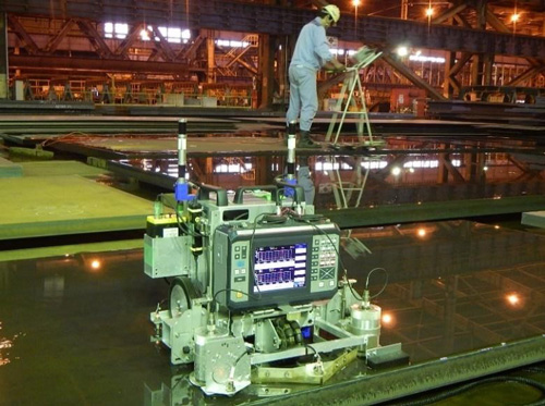Fig. 2: Automated UT-robot and technician performing Manual UT side by side